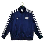 Abrigo Oasis x Adidas 2025