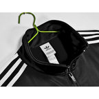 Abrigo Oasis x Adidas 2025